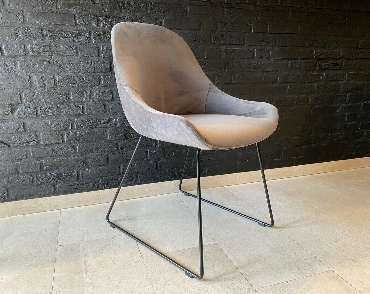 szare krzesło na metalowych płozach, wygodny fotelik z kubełkowym siedziskiem