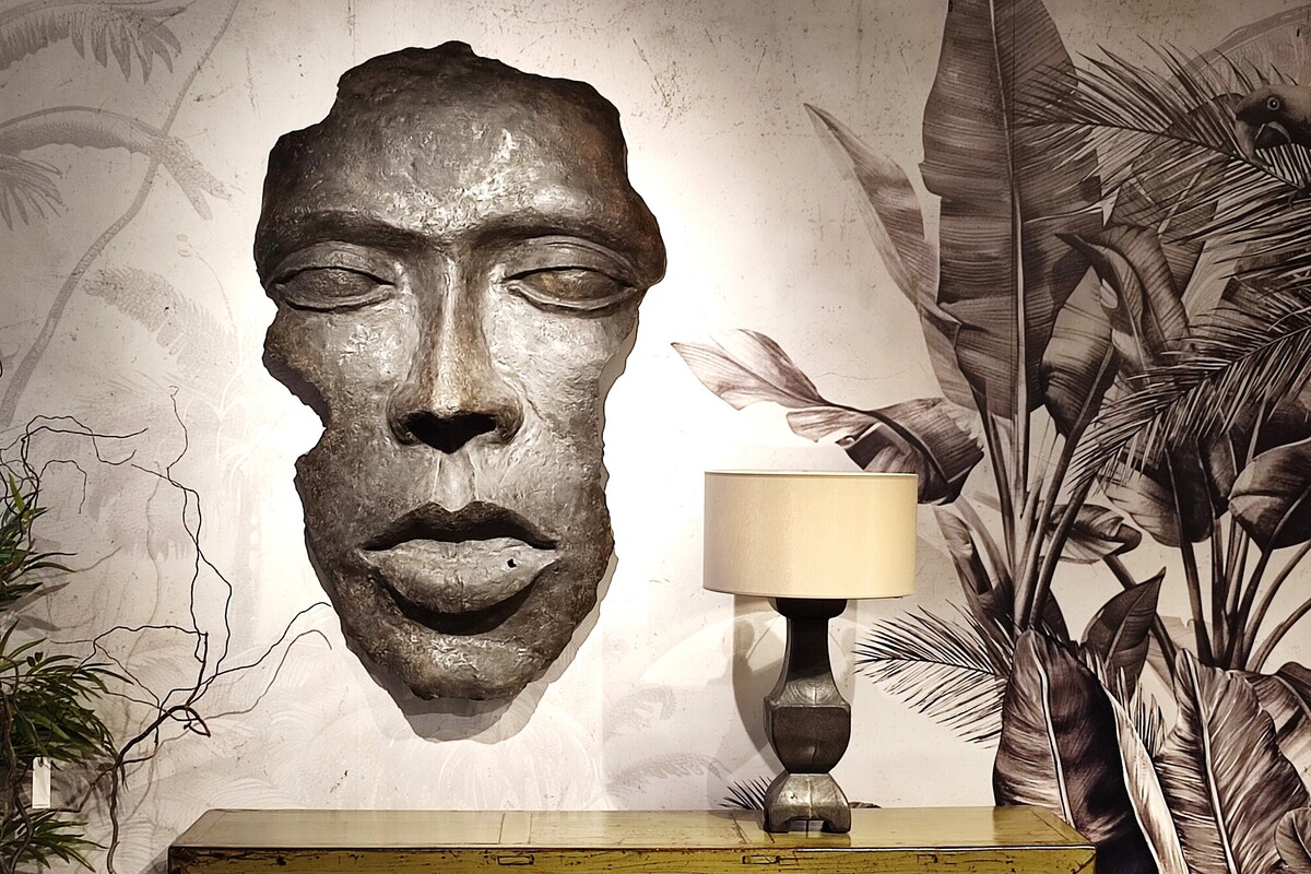 Maska dekoracyjna, ozdoba ścienna, drewniana lampa z beżowym abażurem, tapeta z motywem roślinnym