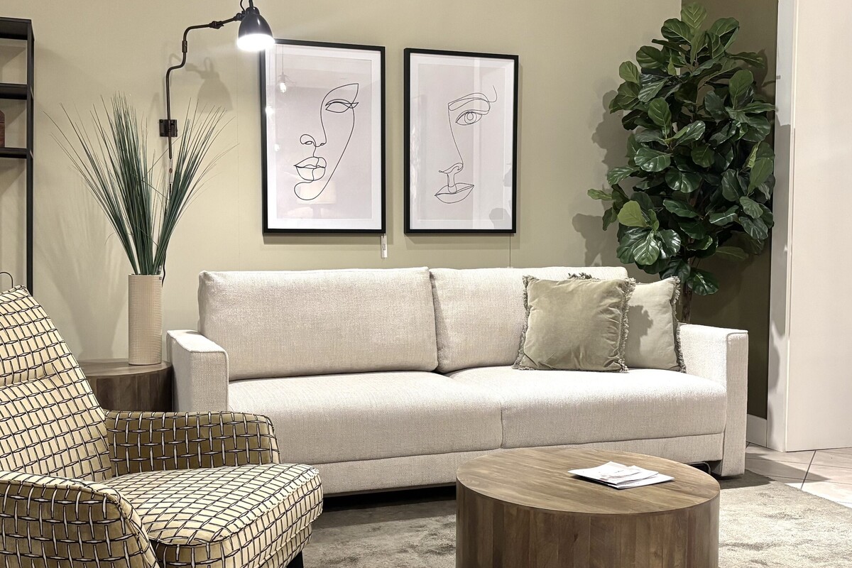 Sofa z funkcją spania z systemem DL. Klasyczna sofa rozkładana do salonu. Oliwkowa ściana w salonie, wygodny fotel w tkaninie Balzac. Zielony dywan, beżowa sofa.